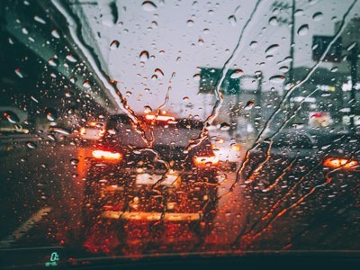 Car breaking in front of driver in rainy weather.